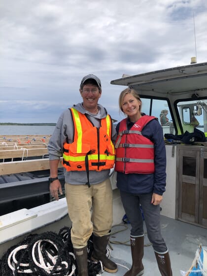 two people standing on a boat