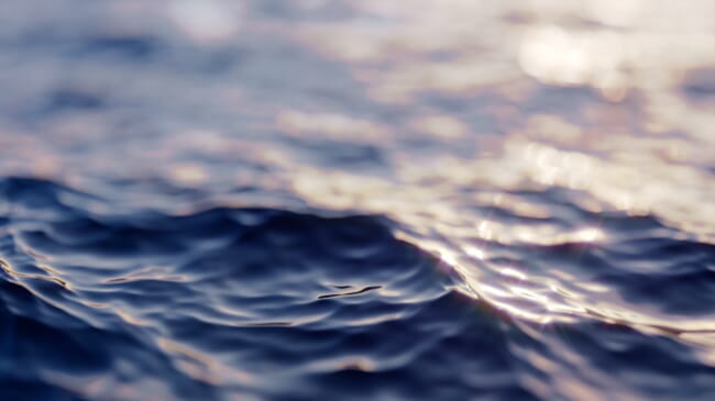 A close-up of small waves on the surface of the sea.